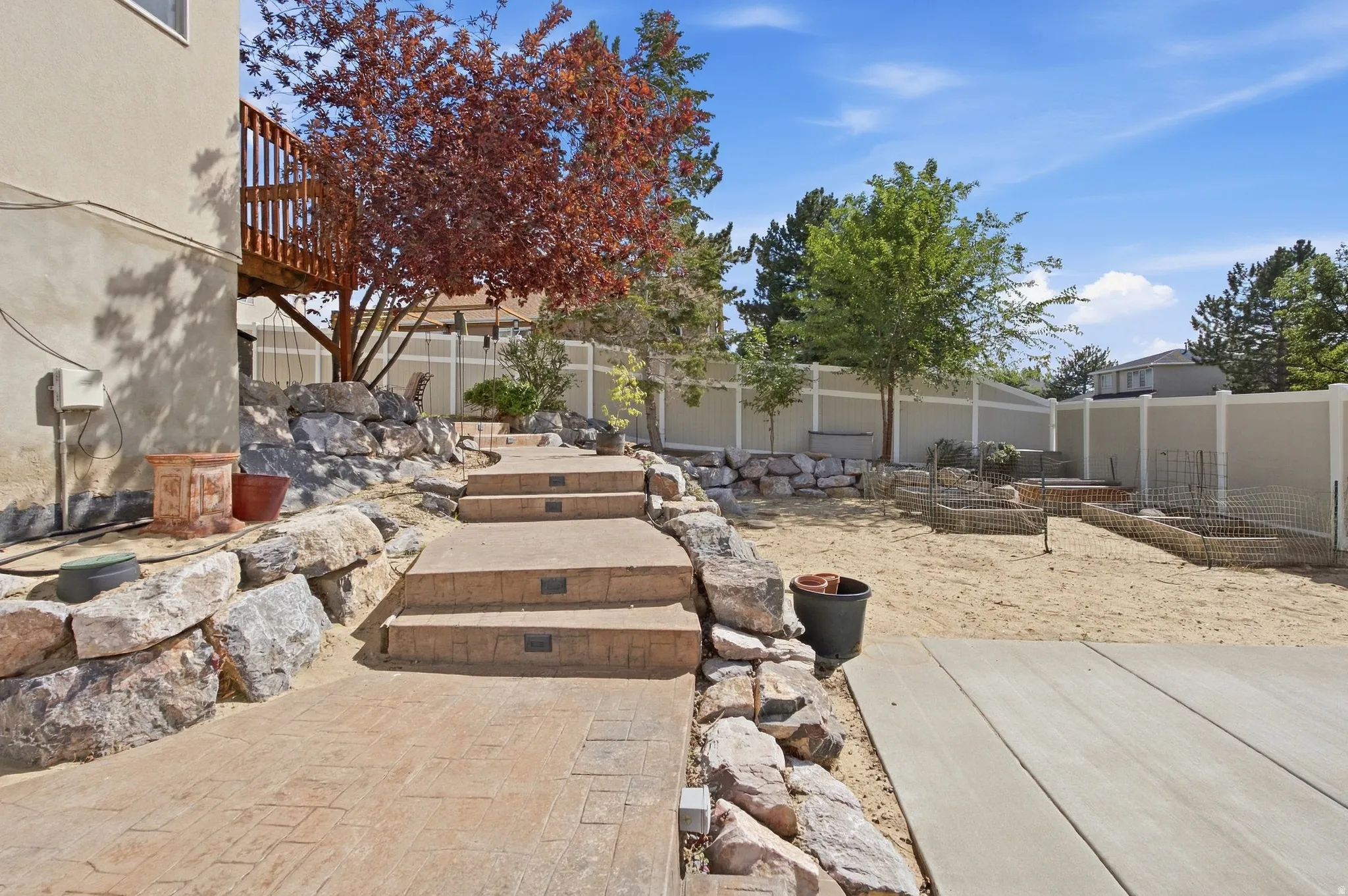 More rockwork with colored, stamped concrete stairs with lighting.
