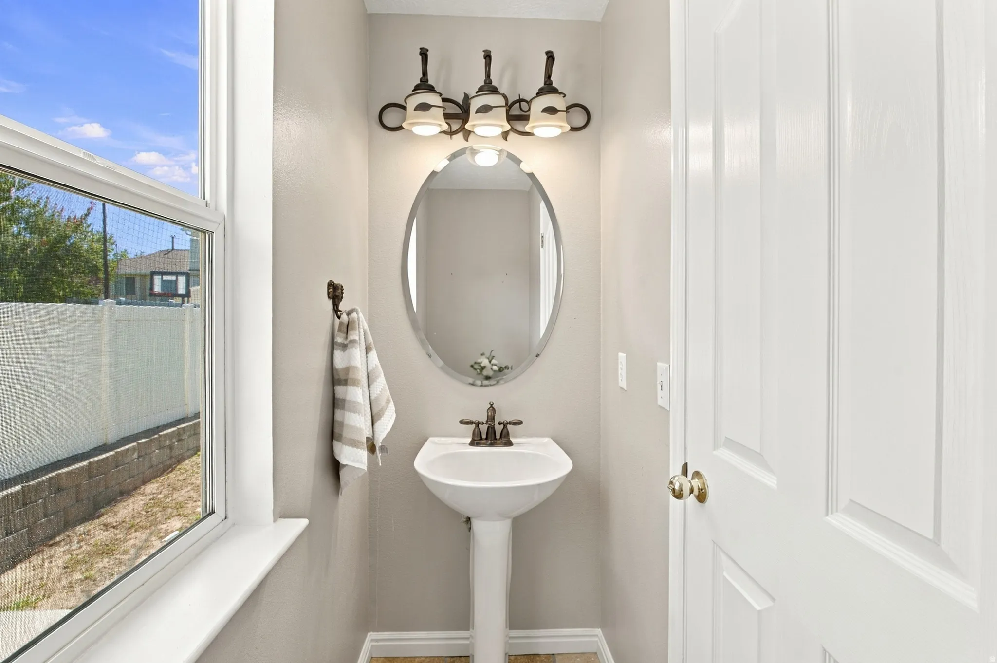 Half bath with window and cellular shade that opens from the top or the bottom.