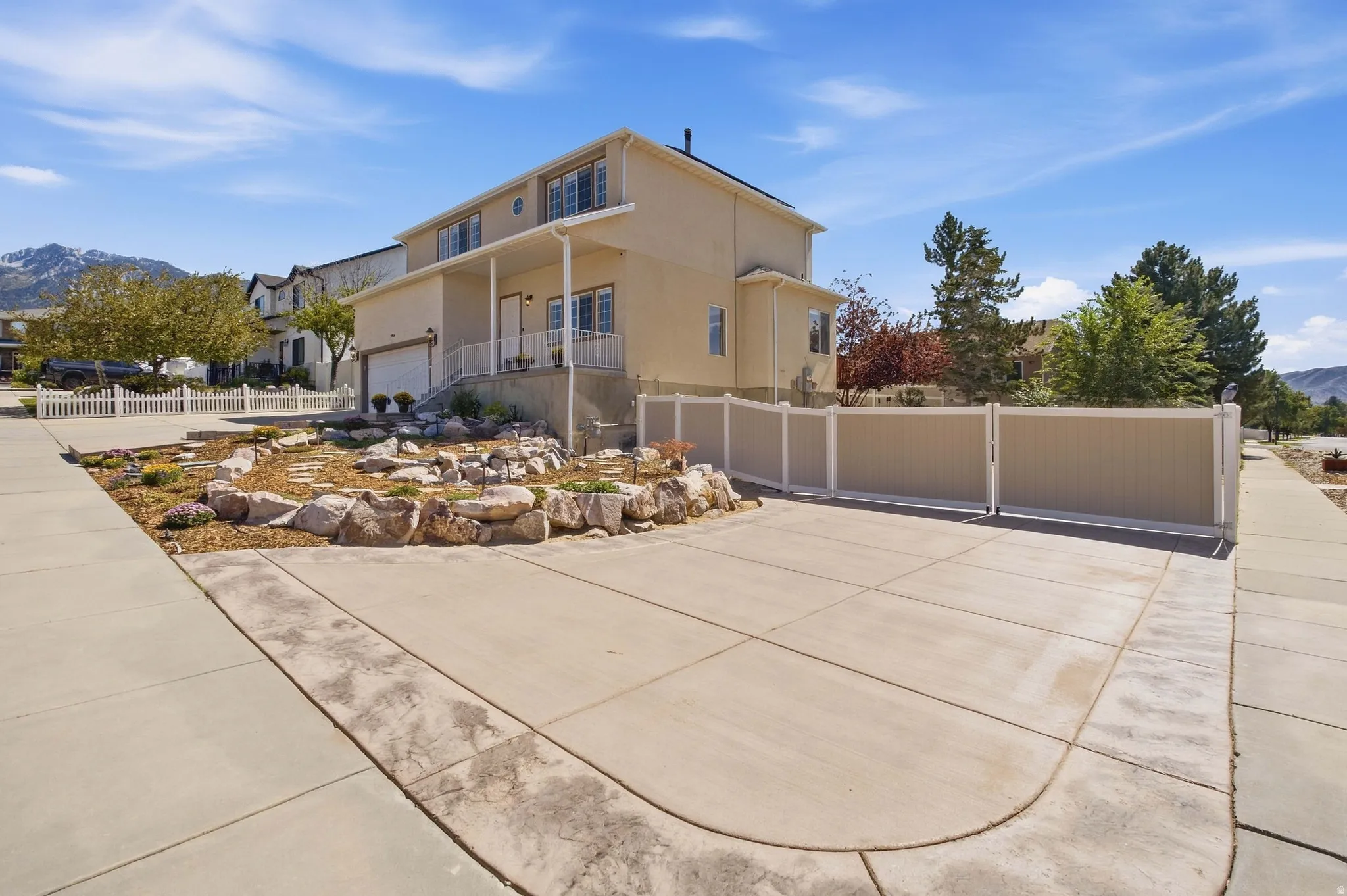More custom concrete and two toned vinyl fence with big gate to bring in big toys.