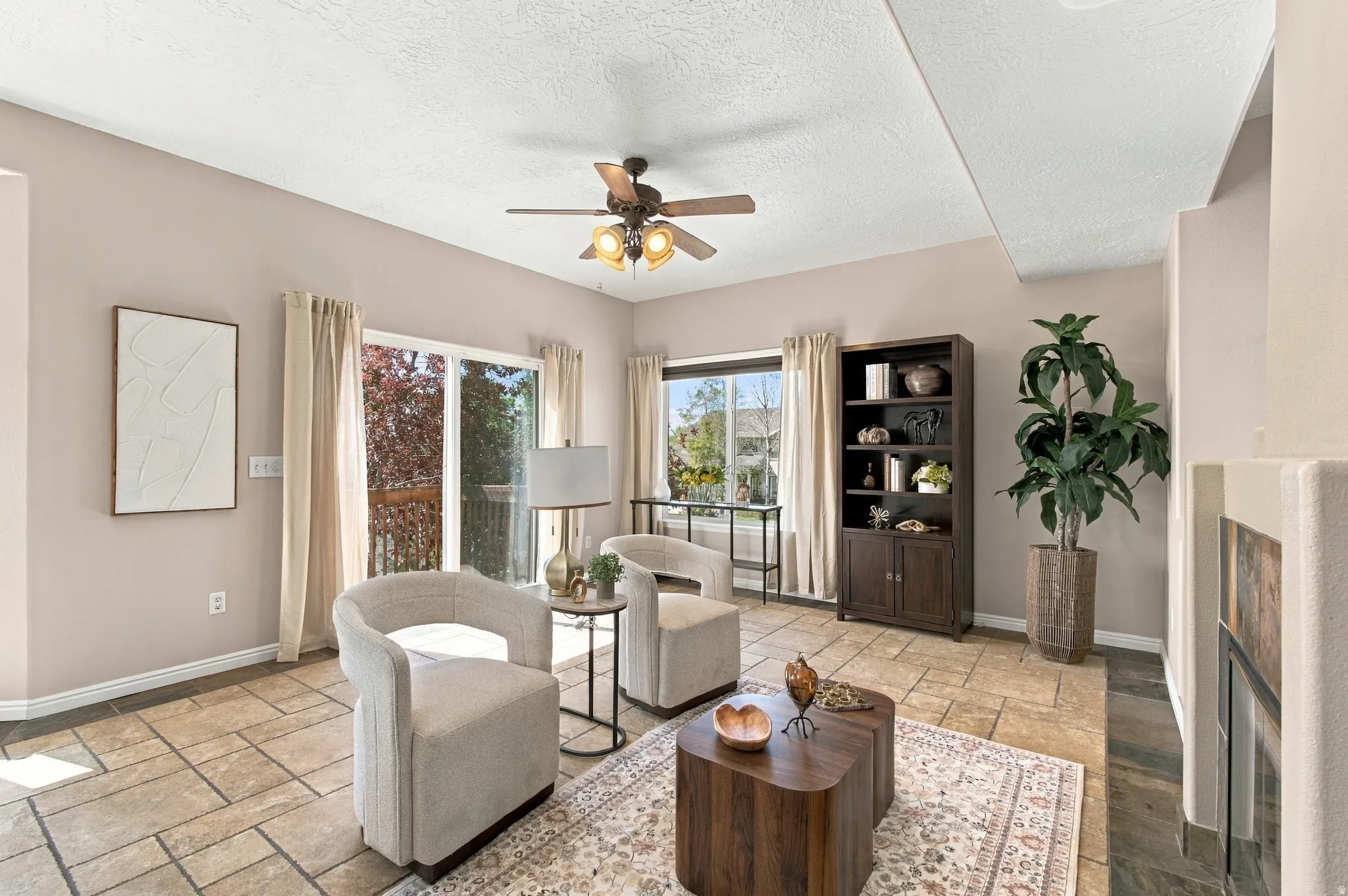 Travertine-style and slate easy to clean floors.  Light and bright family room.