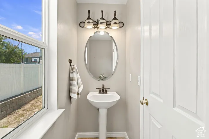 Half bath with window and cellular shade that opens from the top or the bottom.