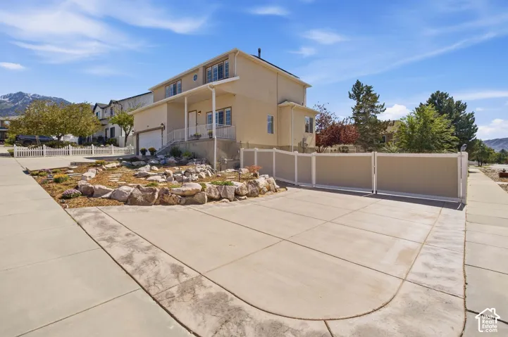 More custom concrete and two toned vinyl fence with big gate to bring in big toys.