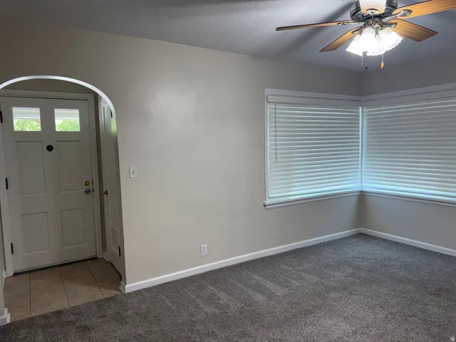 Arched doorway entry to tiled flooring