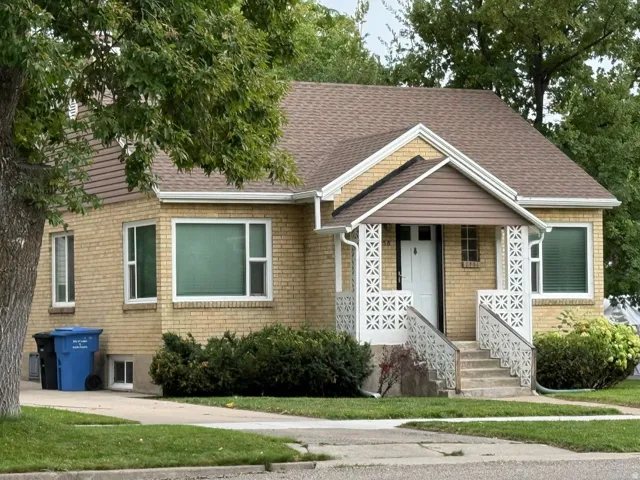Brick exterior with a gabled roof and covered front entry