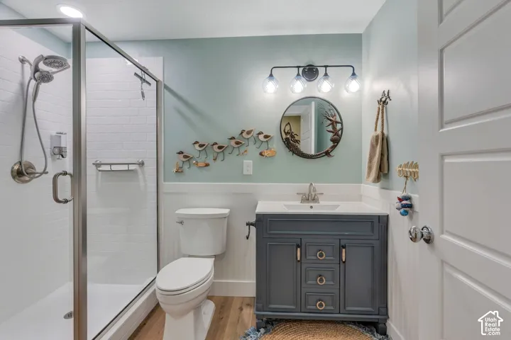 Glass-enclosed shower with white subway tile