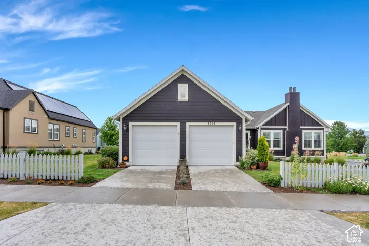 Charcoal-colored siding with white trim and a two-car garage