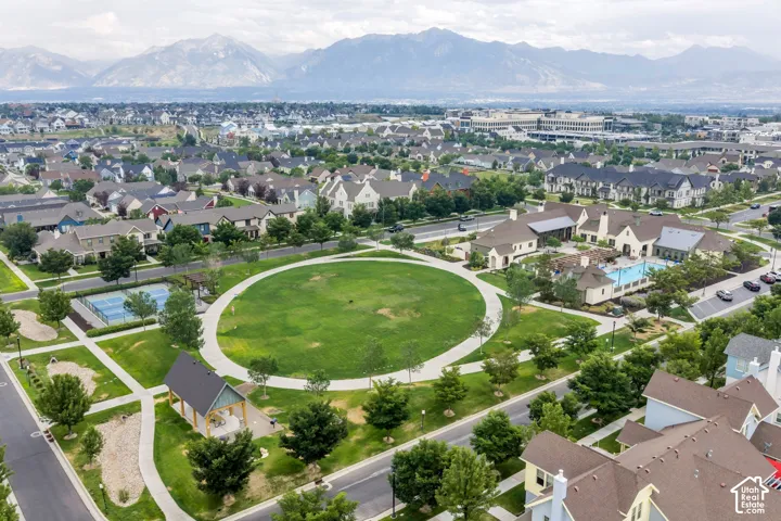 Community green space with a circular walking path, tennis courts, and a swimming pool facility