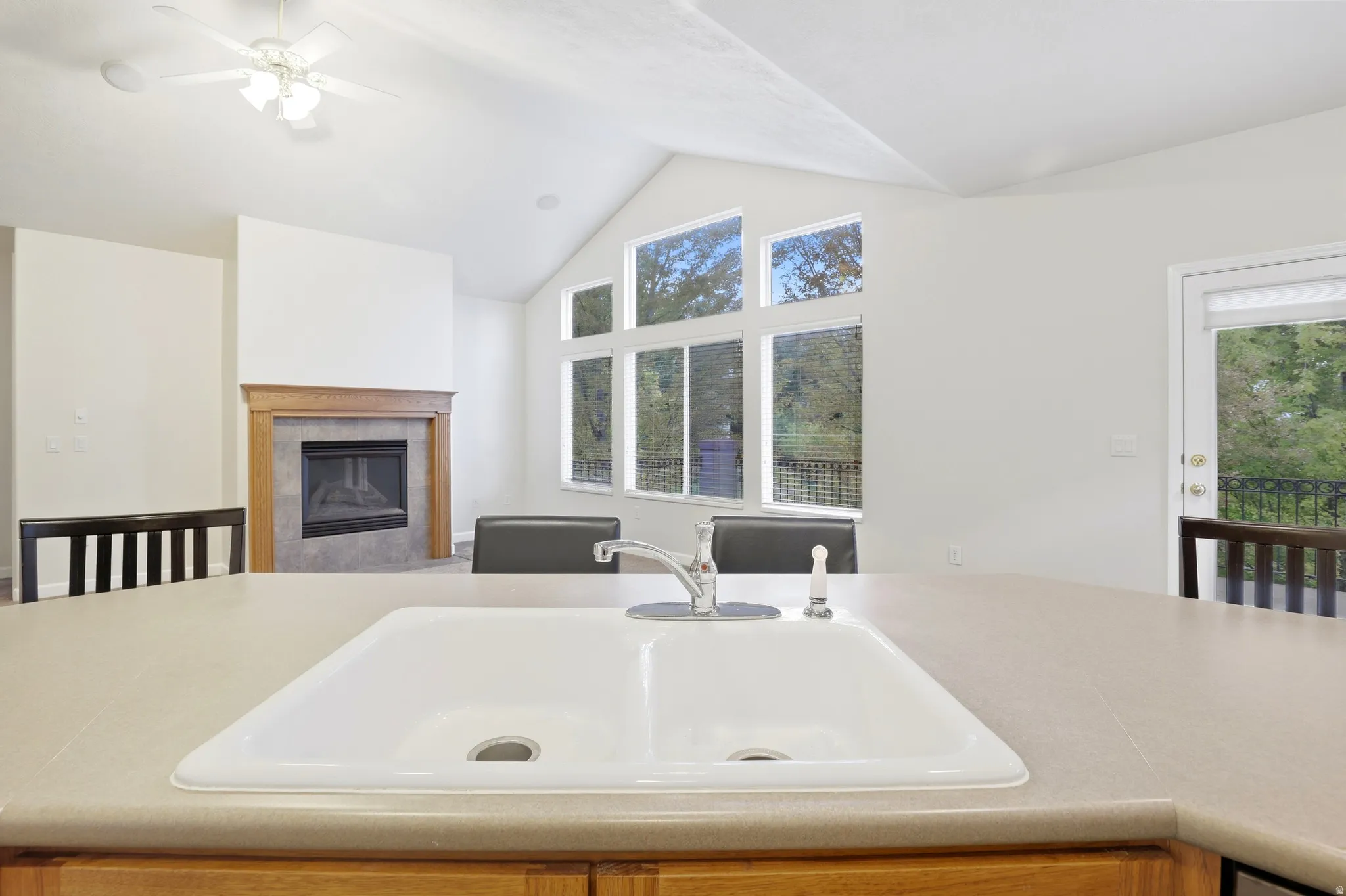 Vaulted ceiling, built-in fireplace, large picture windows, wood-finish mantel, built-in sink with countertop
