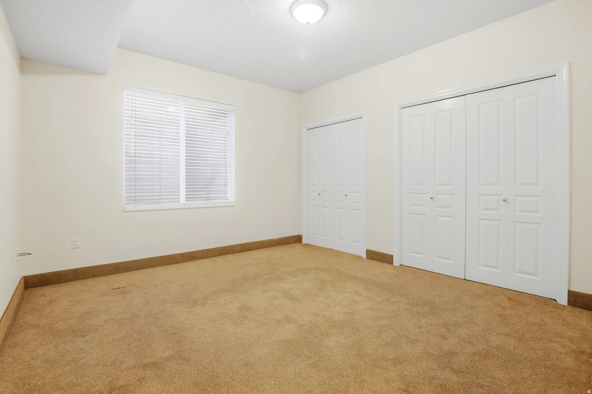 Neutral-toned carpeting with white walls and trim