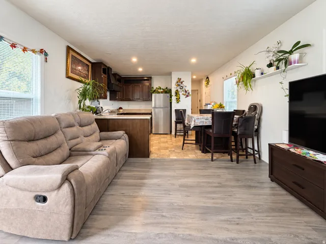 Open-concept living space with wood-finish flooring, recessed lighting, and a white ceiling