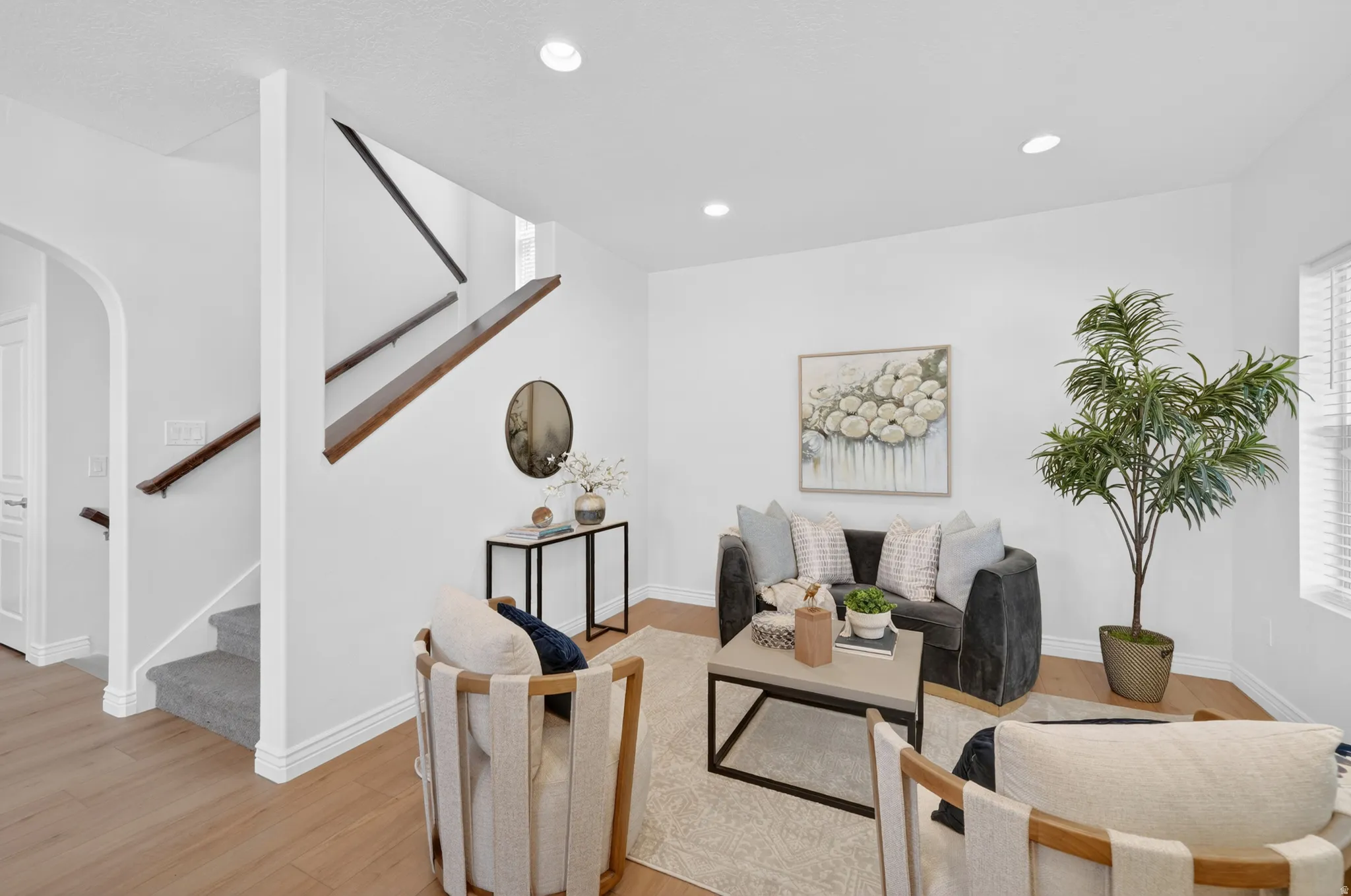 Recessed lighting and wood-finish flooring illuminate this interior