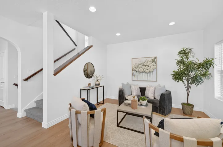 Recessed lighting and wood-finish flooring illuminate this interior