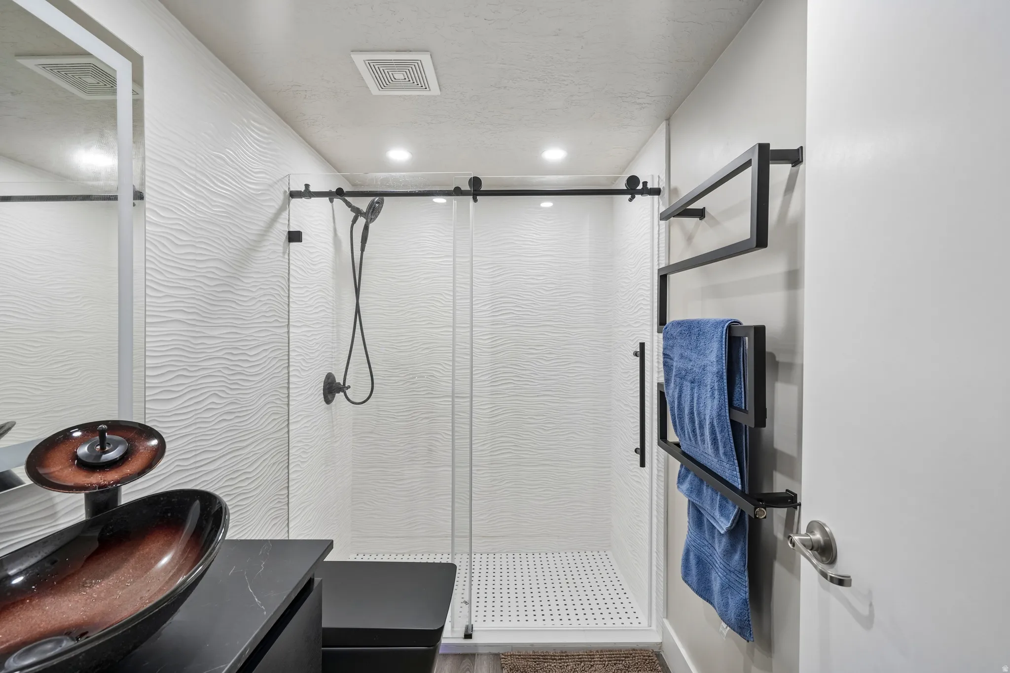 Custom vessel sink with a dark countertop