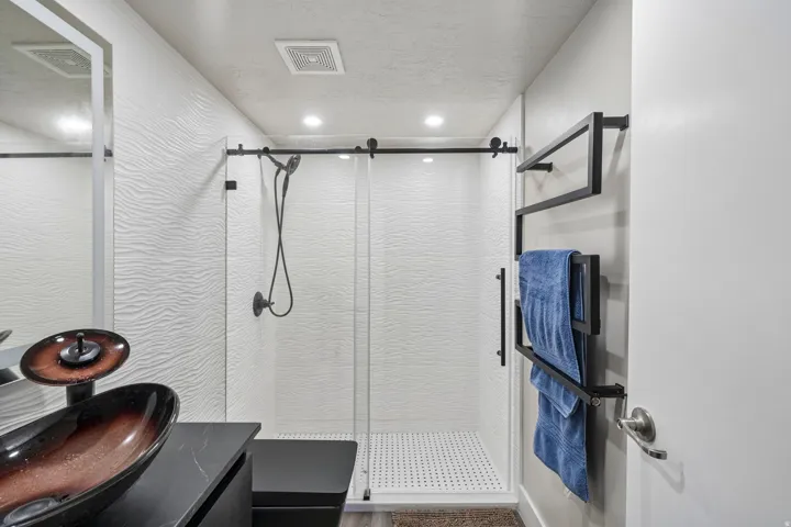 Custom vessel sink with a dark countertop