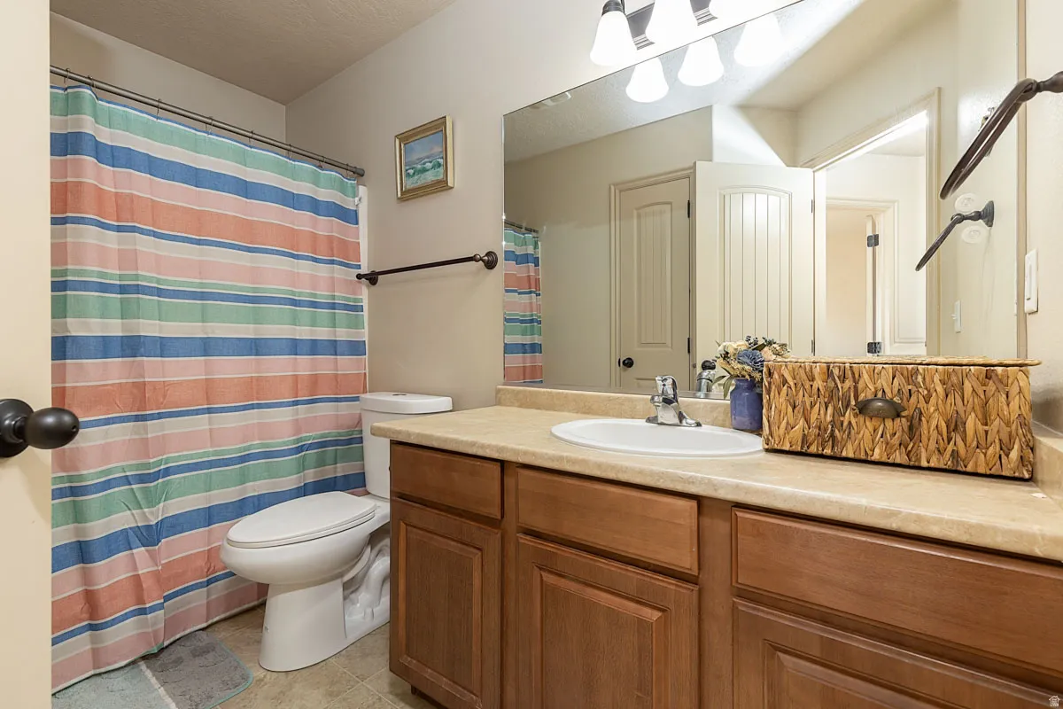 Bathroom vanity featuring a single sink, light-colored countertop, and wood-finish cabinetry