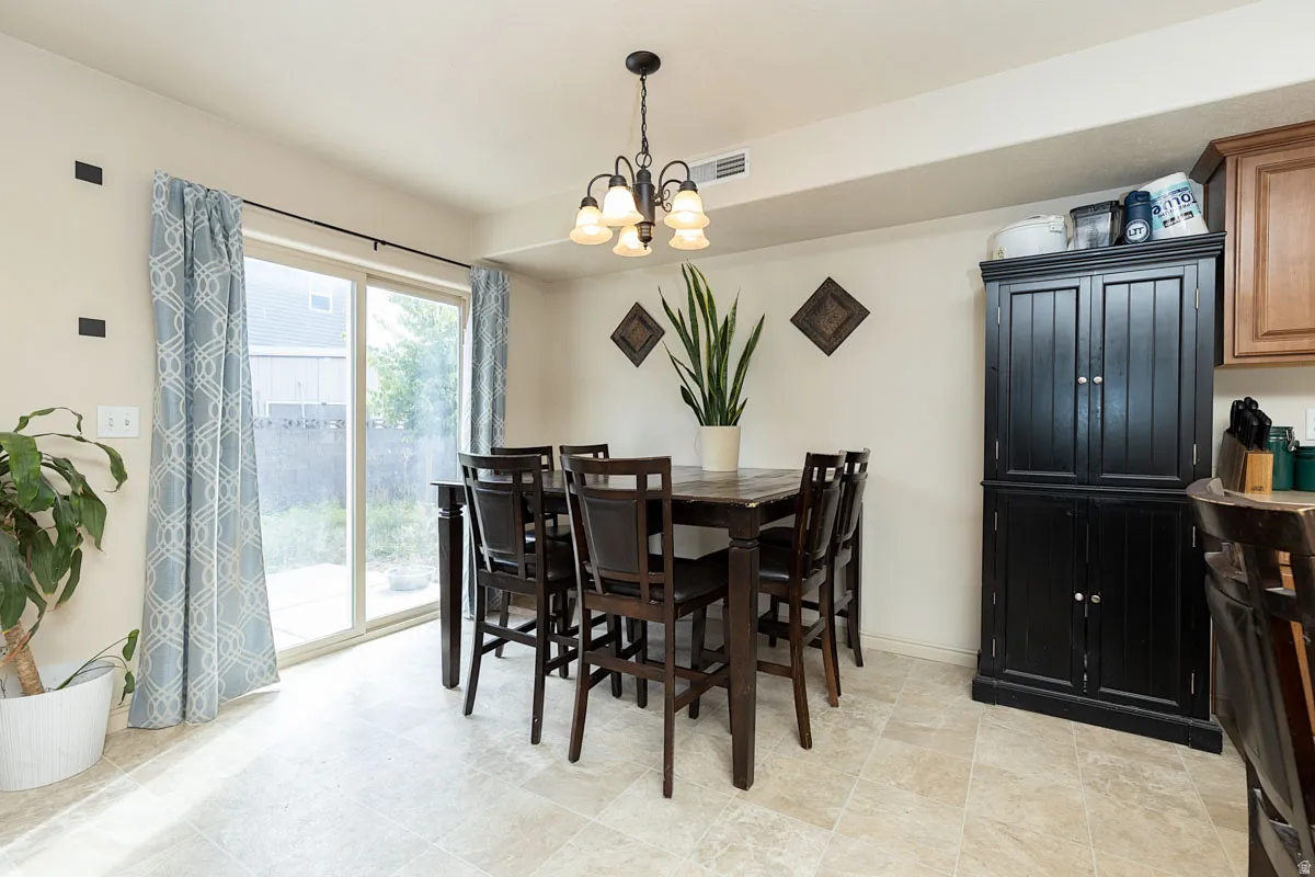 Sliding glass door, tiled flooring, built-in cabinetry, and a ceiling-mounted light fixture