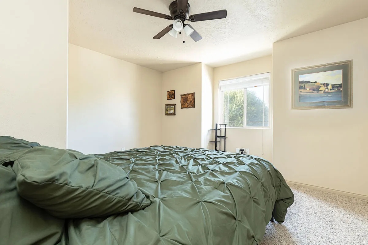 Recessed window offering natural light, textured ceiling, ceiling fan with integrated lighting, and neutral-toned wall paint