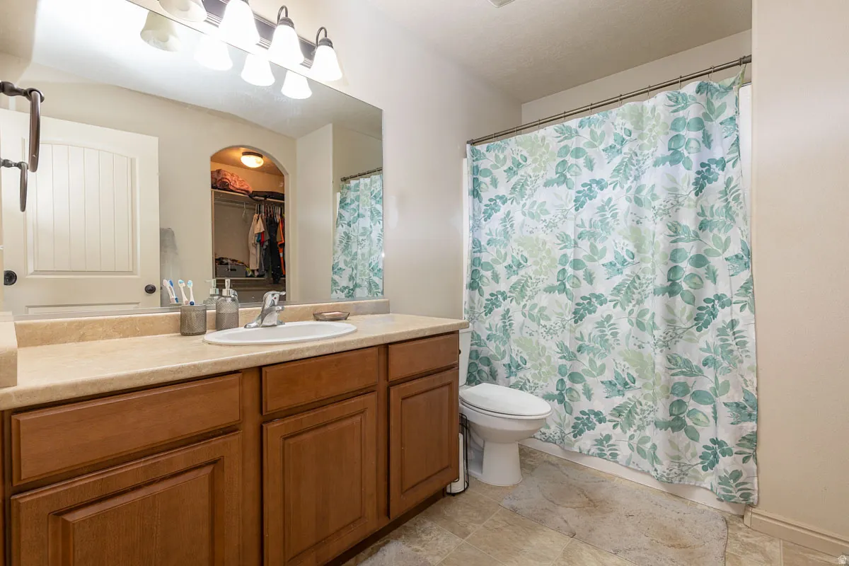 Double vanity with a light-toned countertop and wood-finish cabinetry