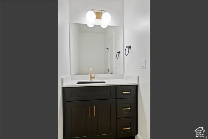 Dark wood-finish vanity with gold-tone hardware