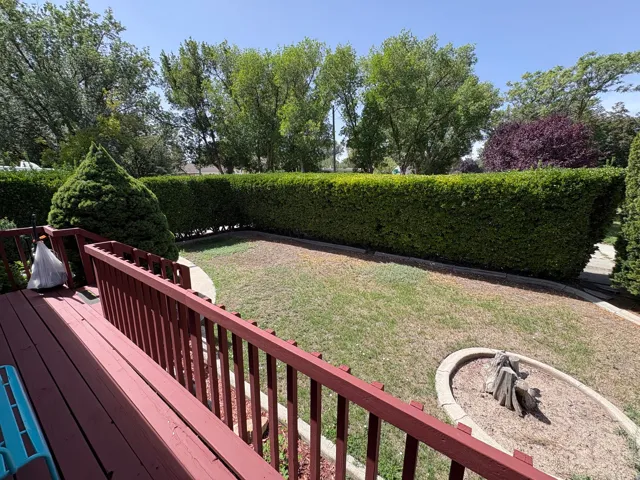 Red-stained wood deck with railings