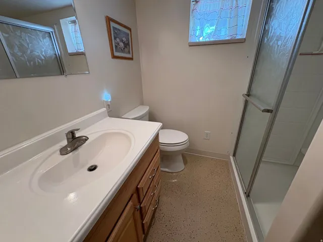 Vanity with an integrated sink, wood-finish cabinetry, and a chrome faucet