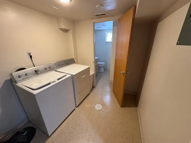 Laundry area with a washer and dryer, durable flooring, and a recessed ceiling light