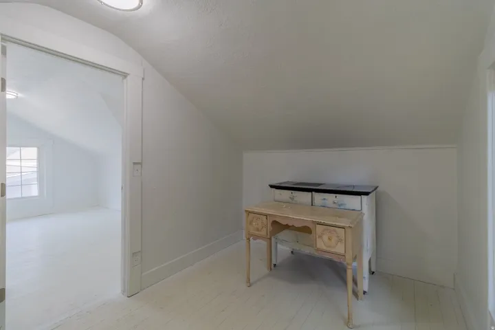 Sloped ceilings with painted wood-finish flooring