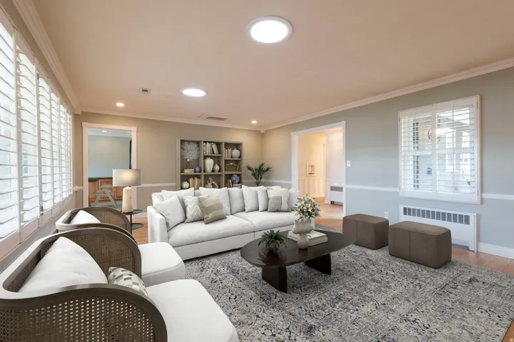 Recessed lighting, crown molding, white plantation shutters, built-in shelving, and wood flooring