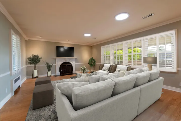 Hardwood flooring, crown molding, chair rail molding, fireplace with mantel, and window shutters