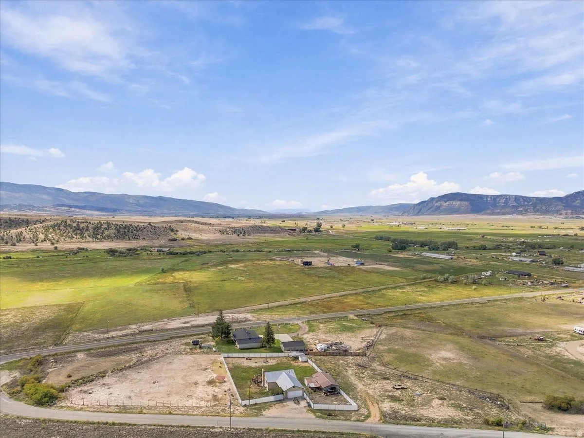 Expansive open land with surrounding mountainous terrain