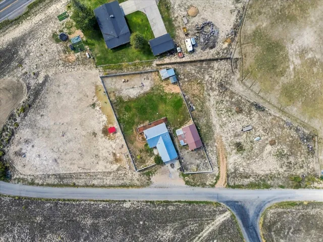 Property featuring multiple structures, road frontage, and expansive undeveloped land