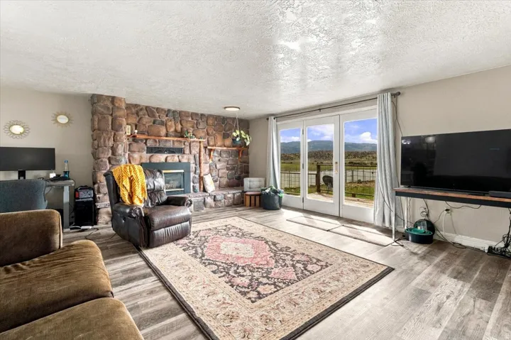 Stone-clad fireplace feature with a built-in hearth