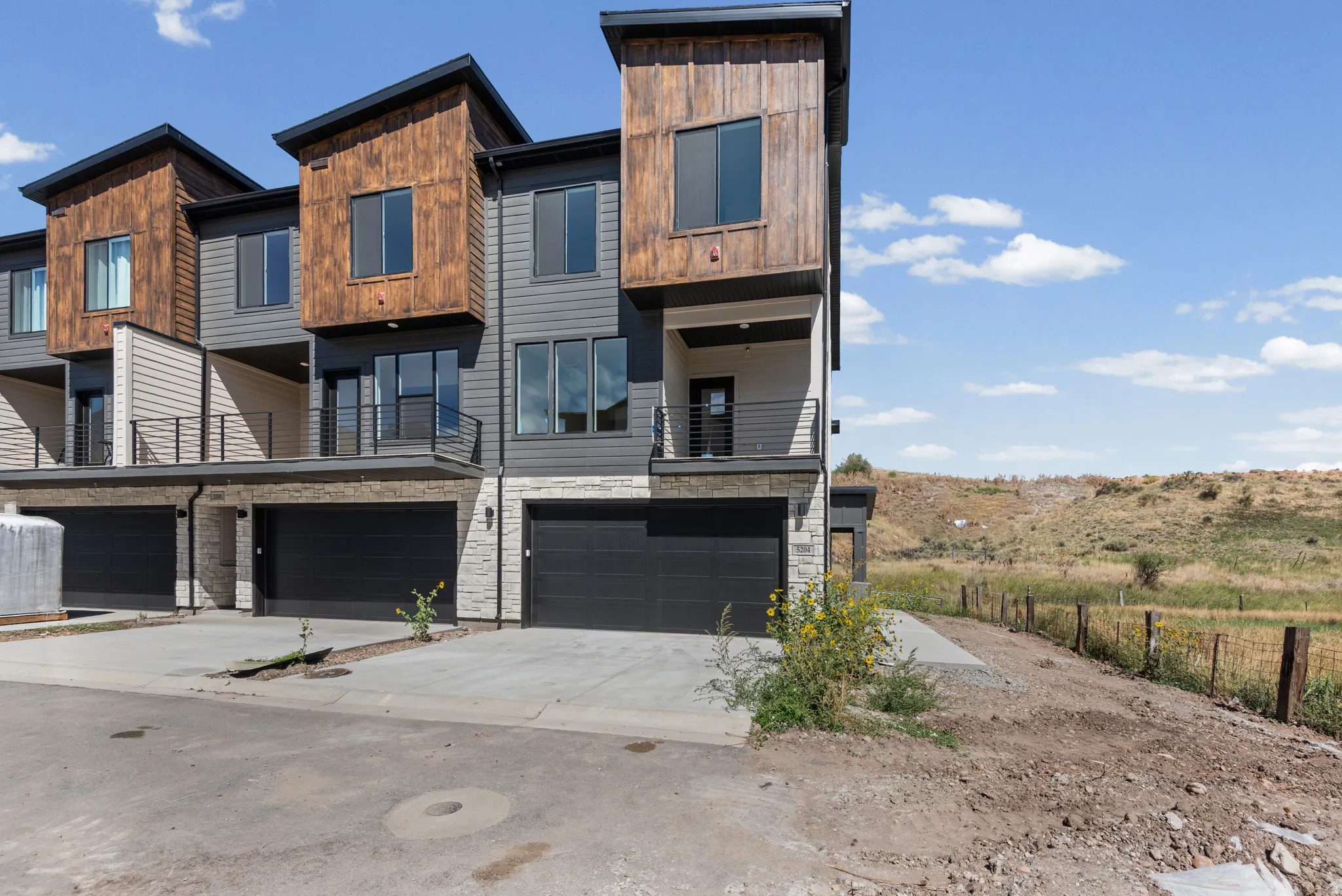 Contemporary multi-level exterior with wood-look and gray siding