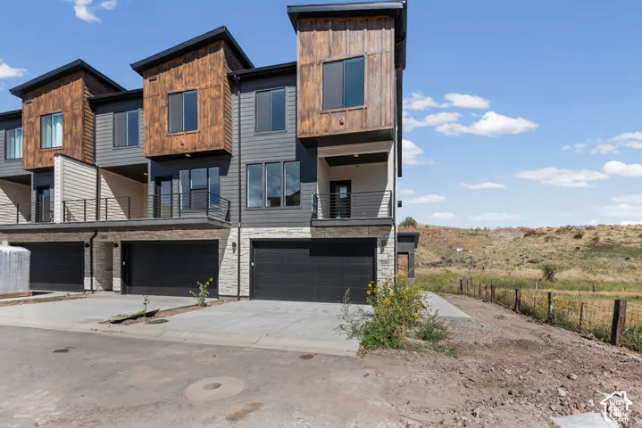 Contemporary multi-level exterior with wood-look and gray siding