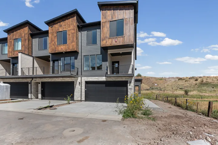 Contemporary multi-level exterior with wood-look and gray siding