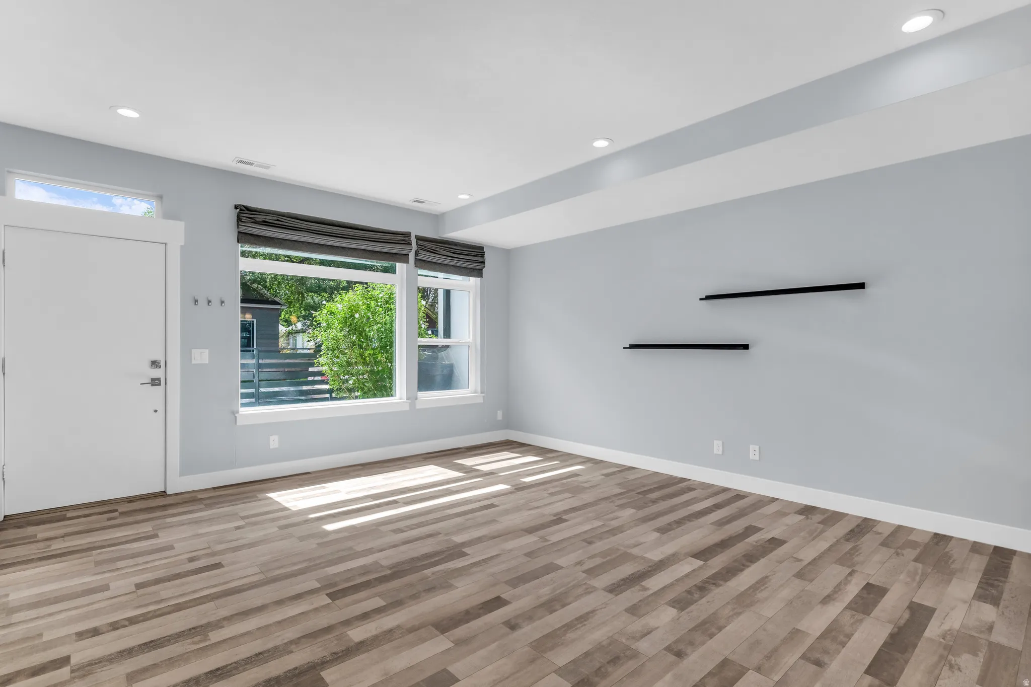 Wood-finish flooring complemented by light-toned wall paint