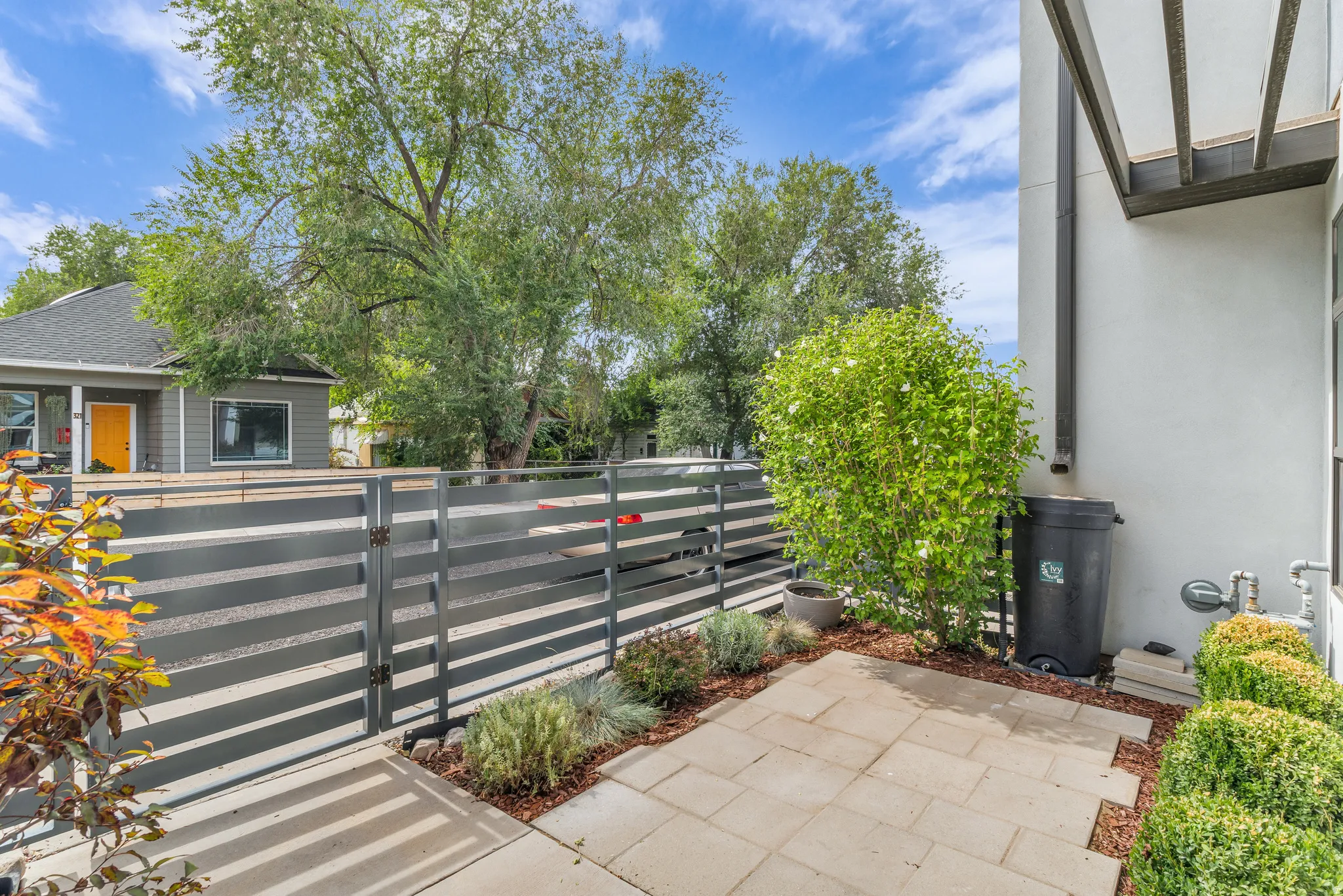Private patio with paver flooring and surrounding landscaping