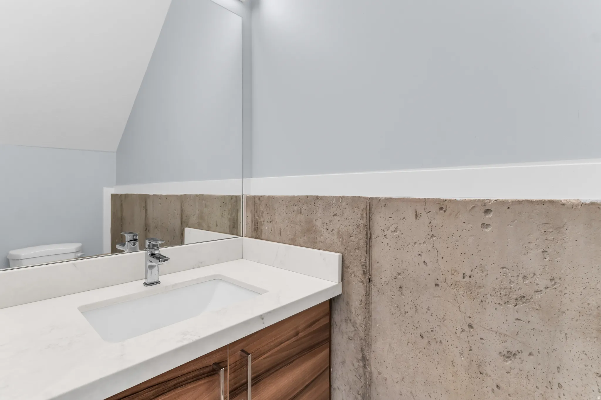 Integrated vanity with a white countertop and rectangular undermount sink