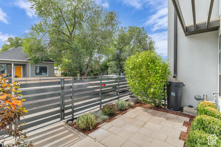 Private patio with paver flooring and surrounding landscaping