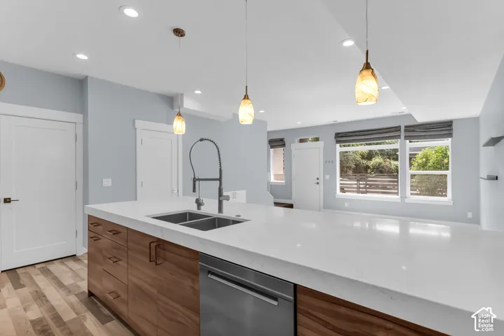 Kitchen island with white countertop, wood-finish cabinetry, and stainless steel appliances