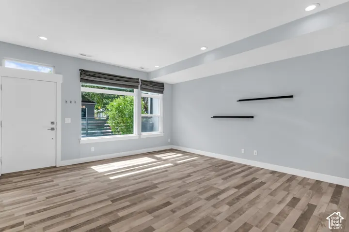 Wood-finish flooring complemented by light-toned wall paint