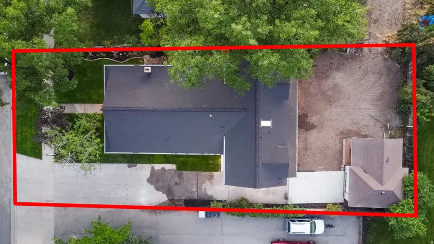 Gable roofline, concrete driveway, detached structure, mature trees, and landscaping