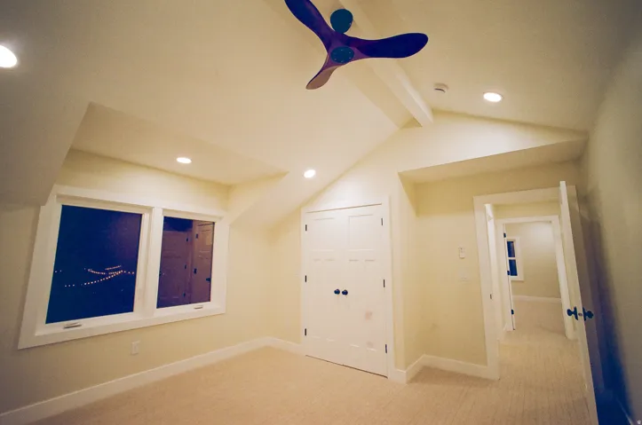Sloped ceilings, recessed lighting, and a ceiling fan