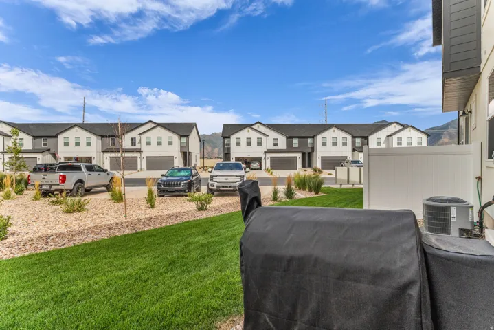 Manicured lawn with a white privacy fence and gravel landscaping