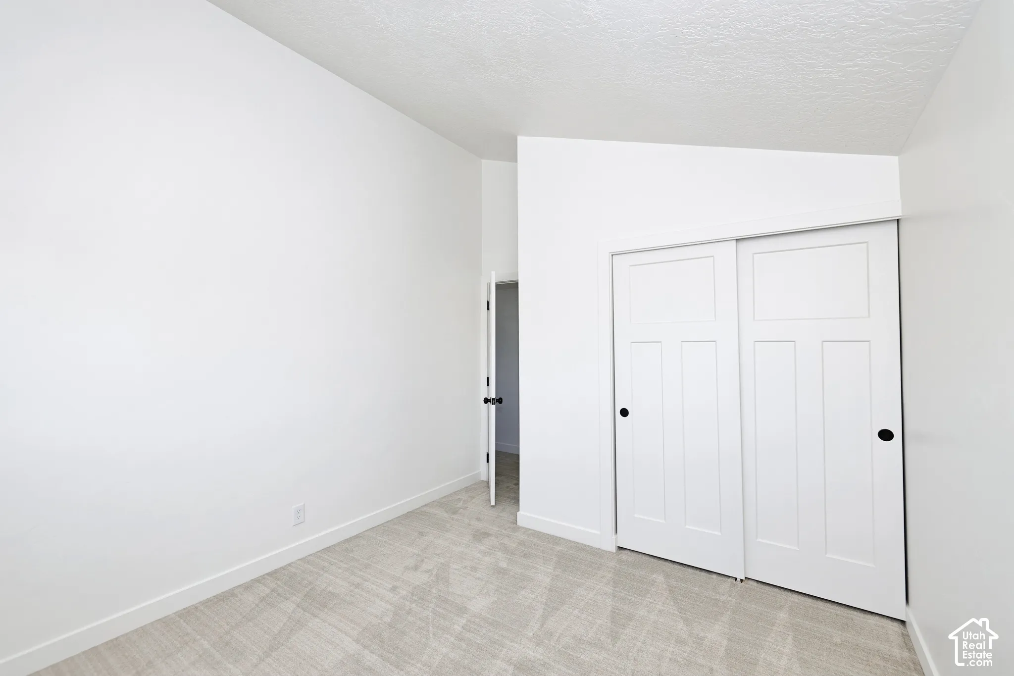 Soft-hued carpet flooring complements neutral wall tones