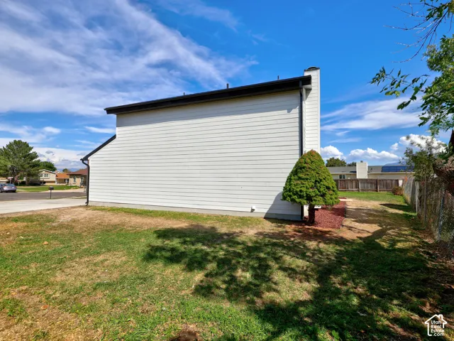 White horizontal siding exterior with black roofline and downspout