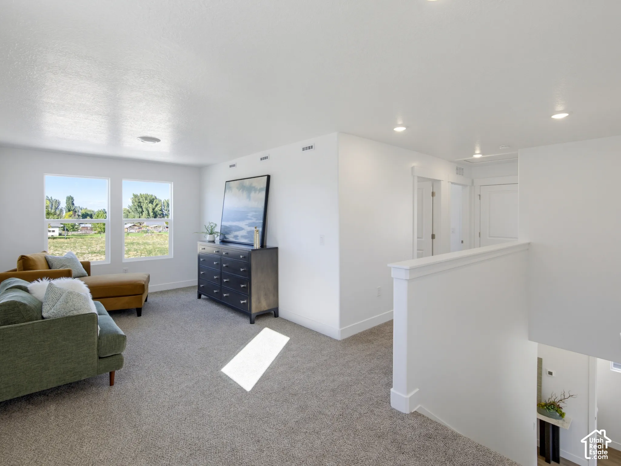 Neutral carpeting, recessed lighting, double-pane windows, and minimalist trim detailing