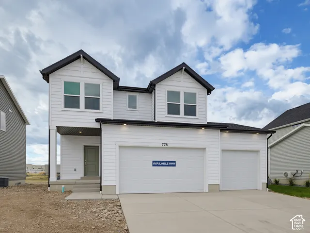 Two-story exterior featuring white horizontal siding, dual front-facing gables, a covered entryway, and a three-car garage