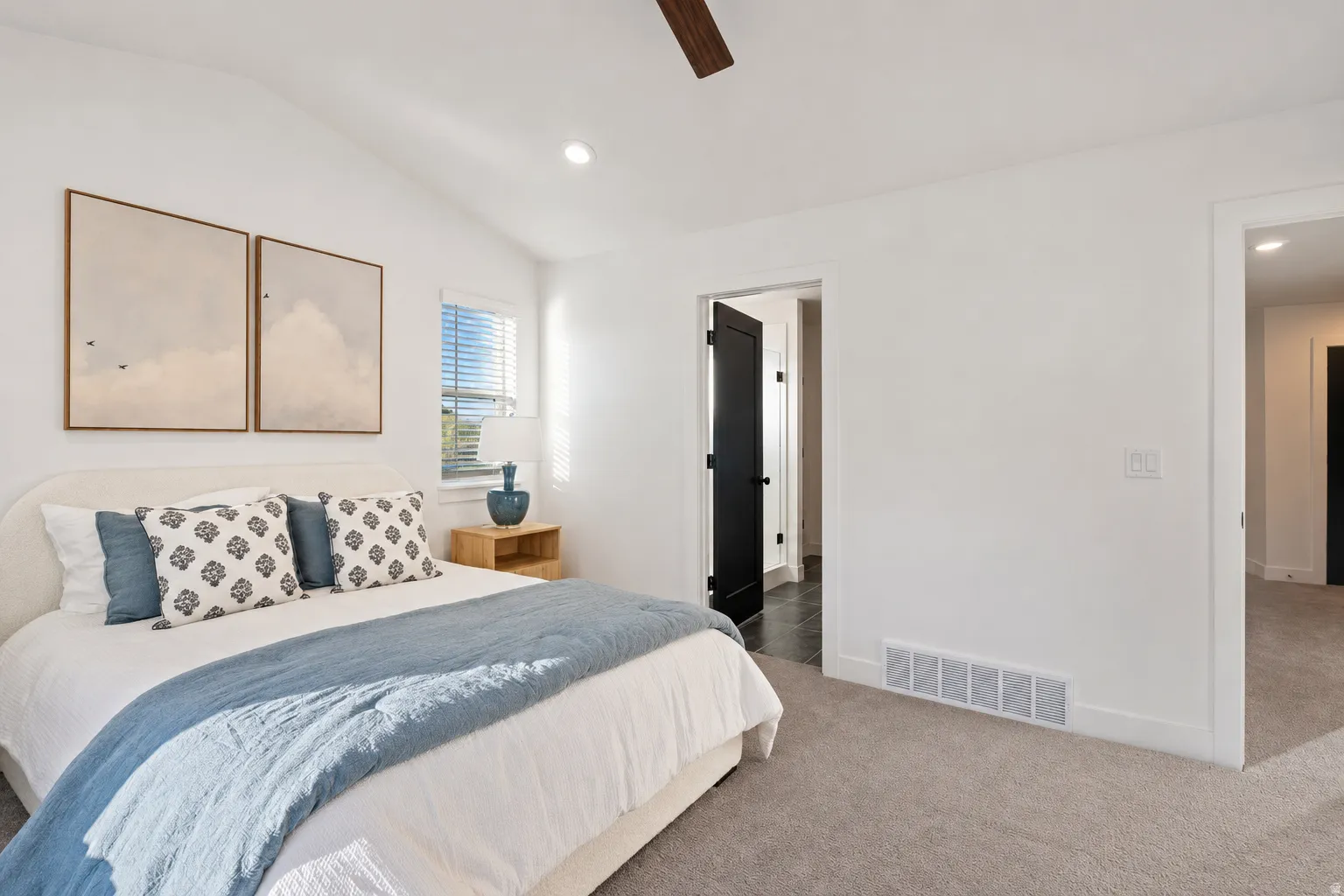 Vaulted ceiling with recessed lighting and a ceiling fan