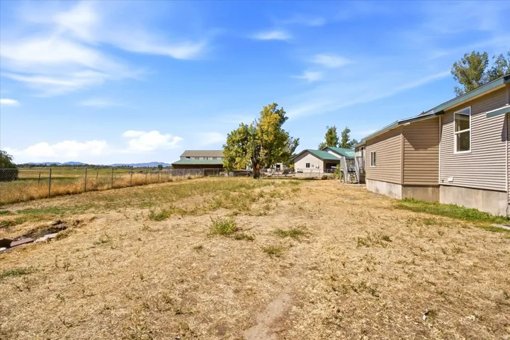 Expansive property with a wire fence perimeter and mature trees